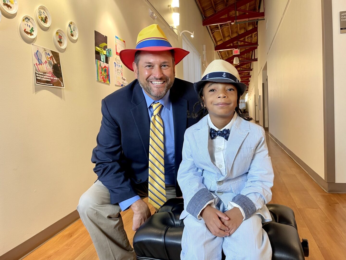 A man in a suit and a boy in a hat with promising careers ahead.