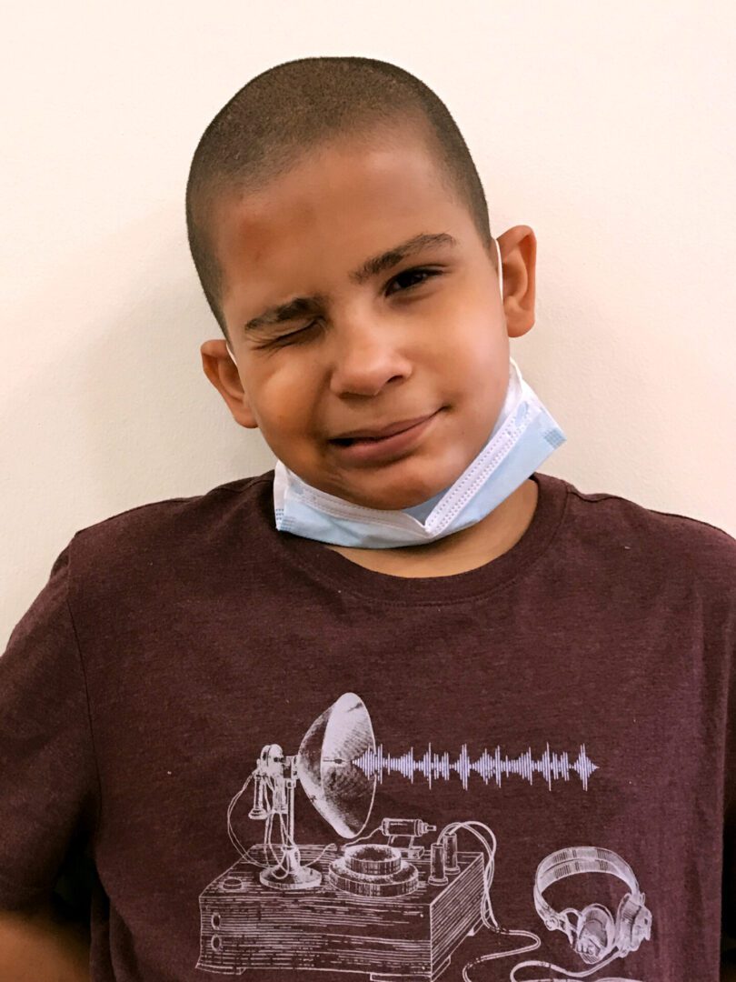 A creative boy wearing a surgical mask and a t-shirt, highlighting the importance of creativity in education.