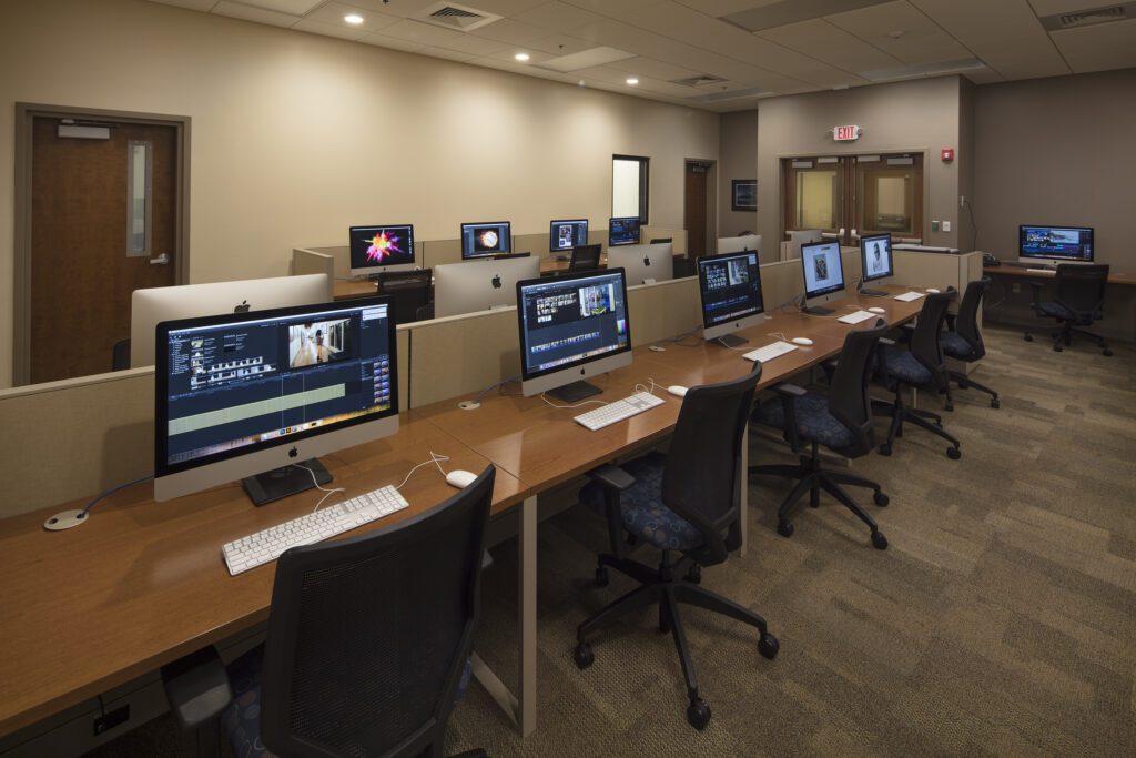 Digital room with several computers and monitors.