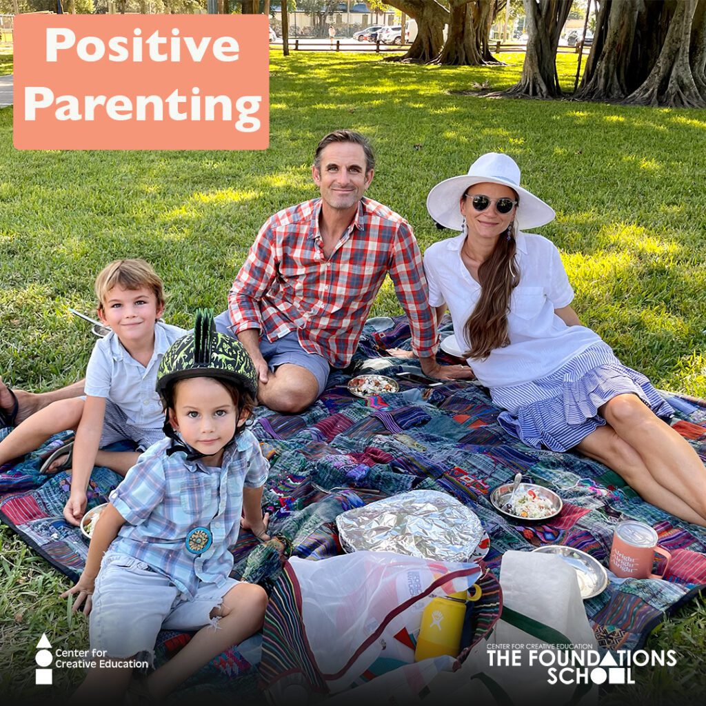 A family practices positive parenting while sitting on a blanket in the park, fostering healthy child behaviors.