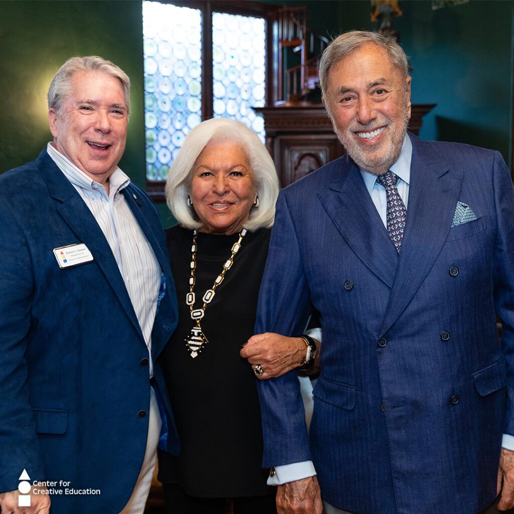 Two men and an older woman posing for a telesco photo.