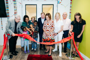 People gathering at a ribbon cutting ceremony