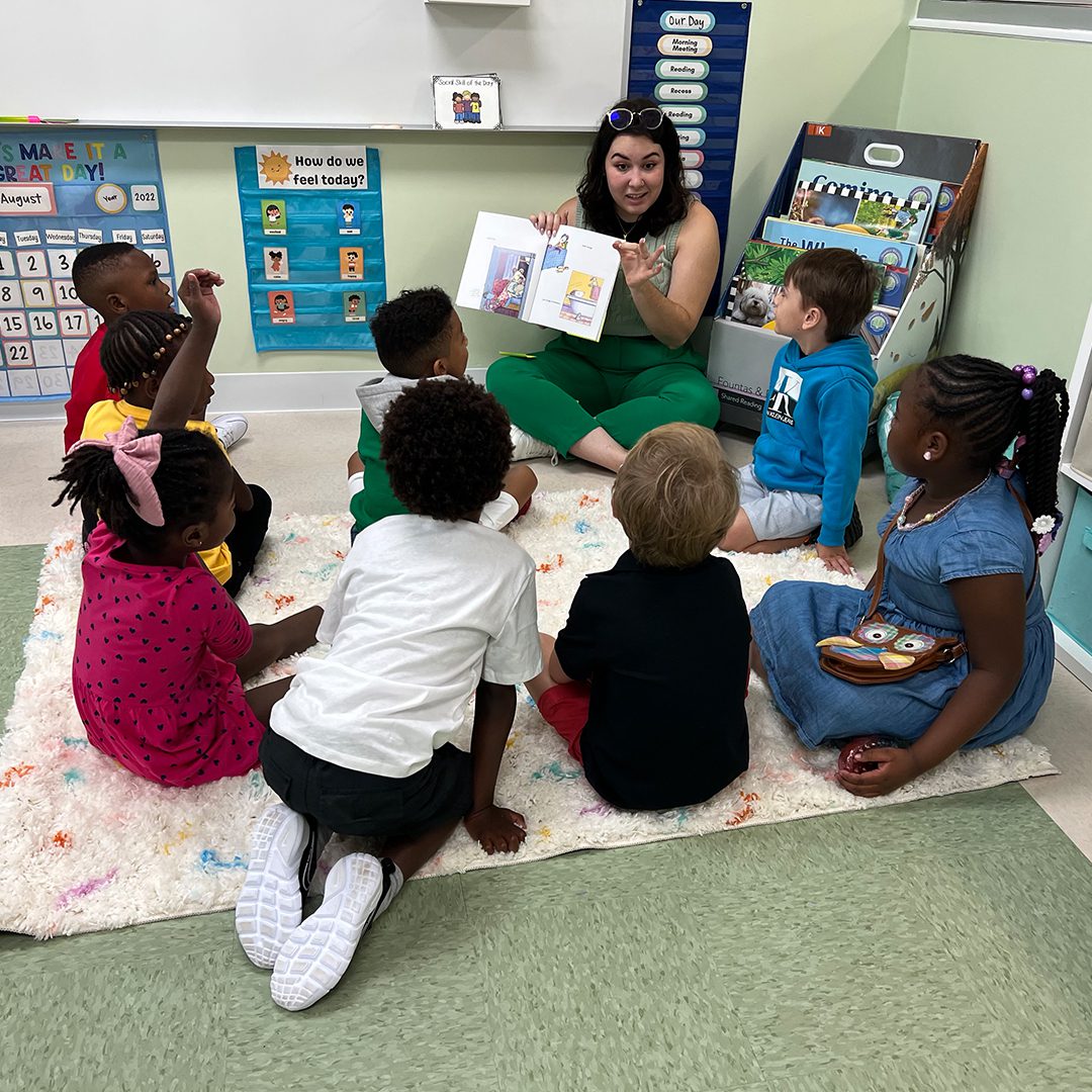 A woman reading to children at a West Palm Beach summer camp classroom.