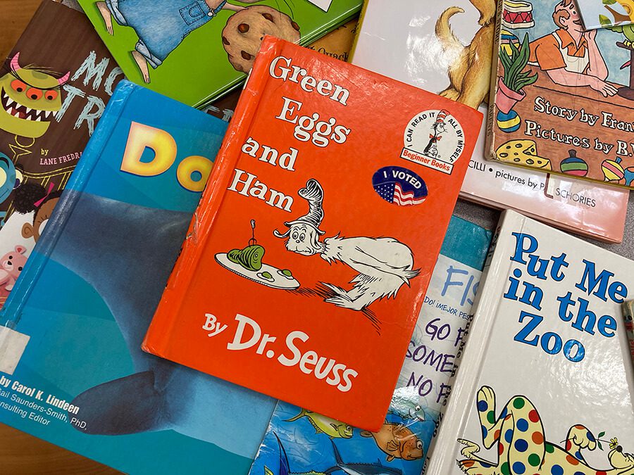 A collection of Dr. Seuss books on a table, featuring an unexpected message from the president.