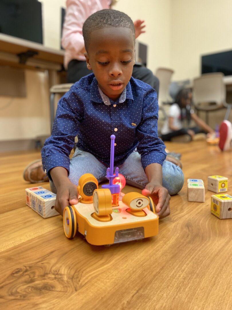 A Boy Playing With Toys and Components