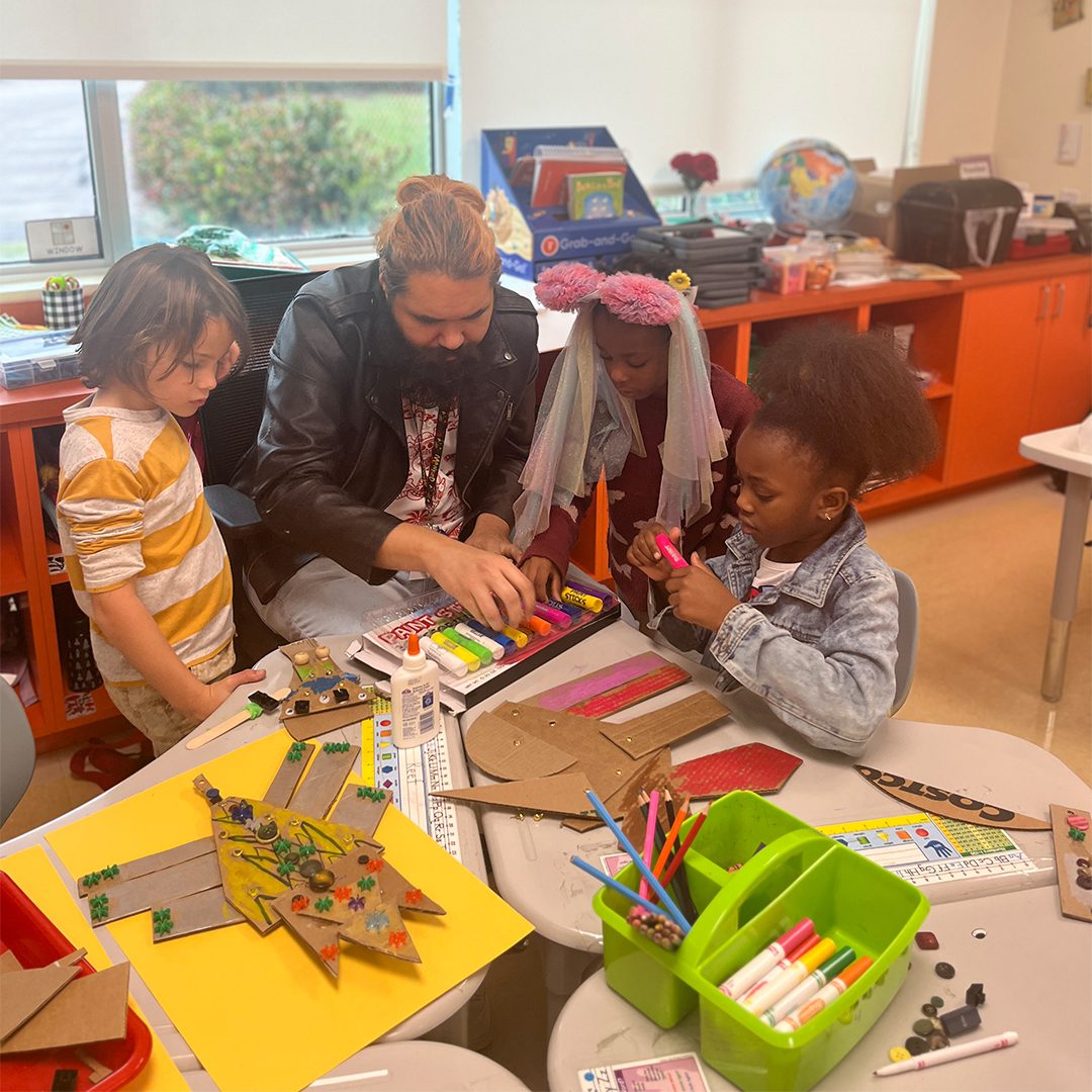 A group of children working on a project in a classroom.