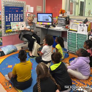 Teacher reading to children in a classroom.