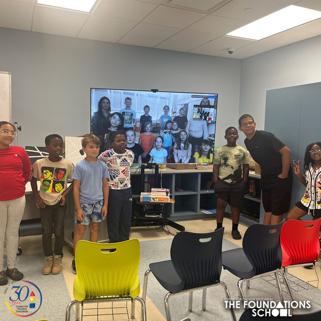 Students in classroom watching video call.