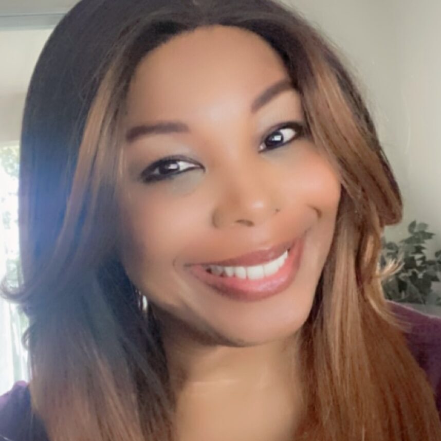 Woman with long brown hair smiling.