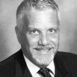 Black and white headshot of a man.