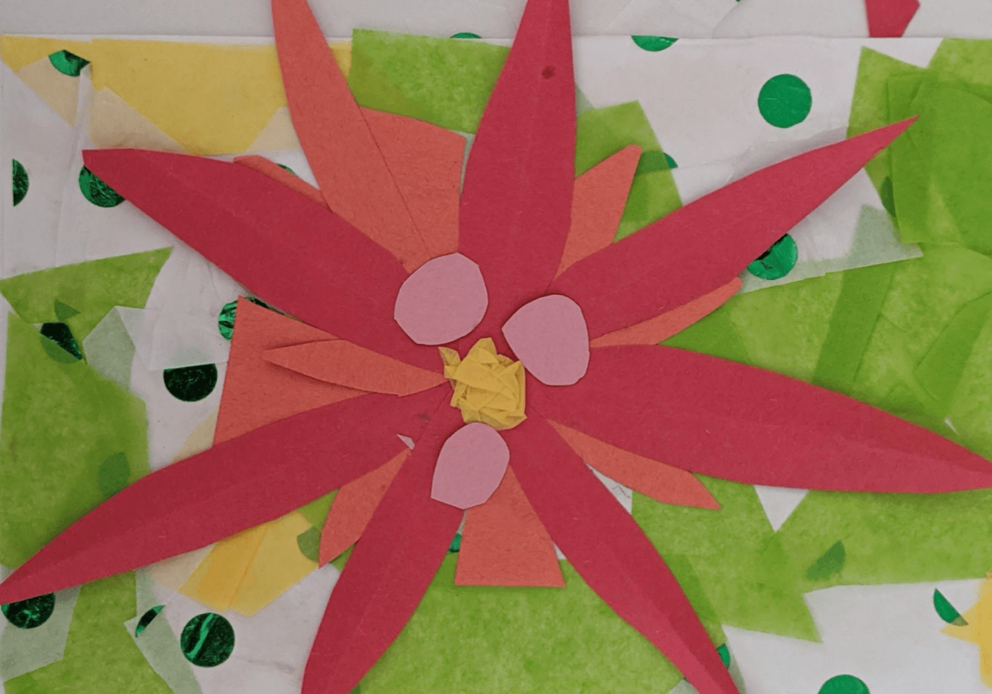 A red and green paper flower with polka dots on it, delivering a message from the president.