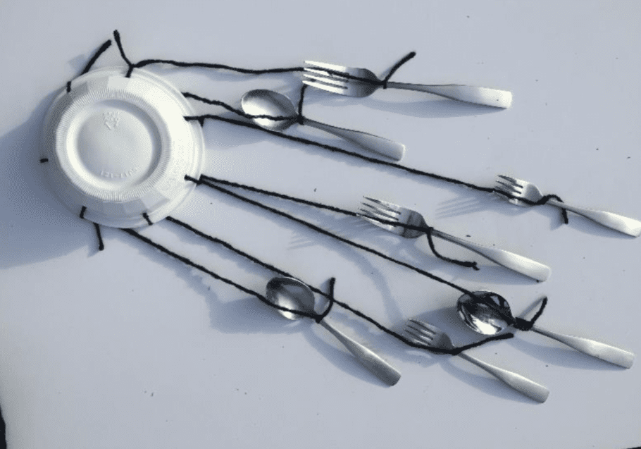 A plate with virtual spoons and forks hanging from it, showcasing creativity.